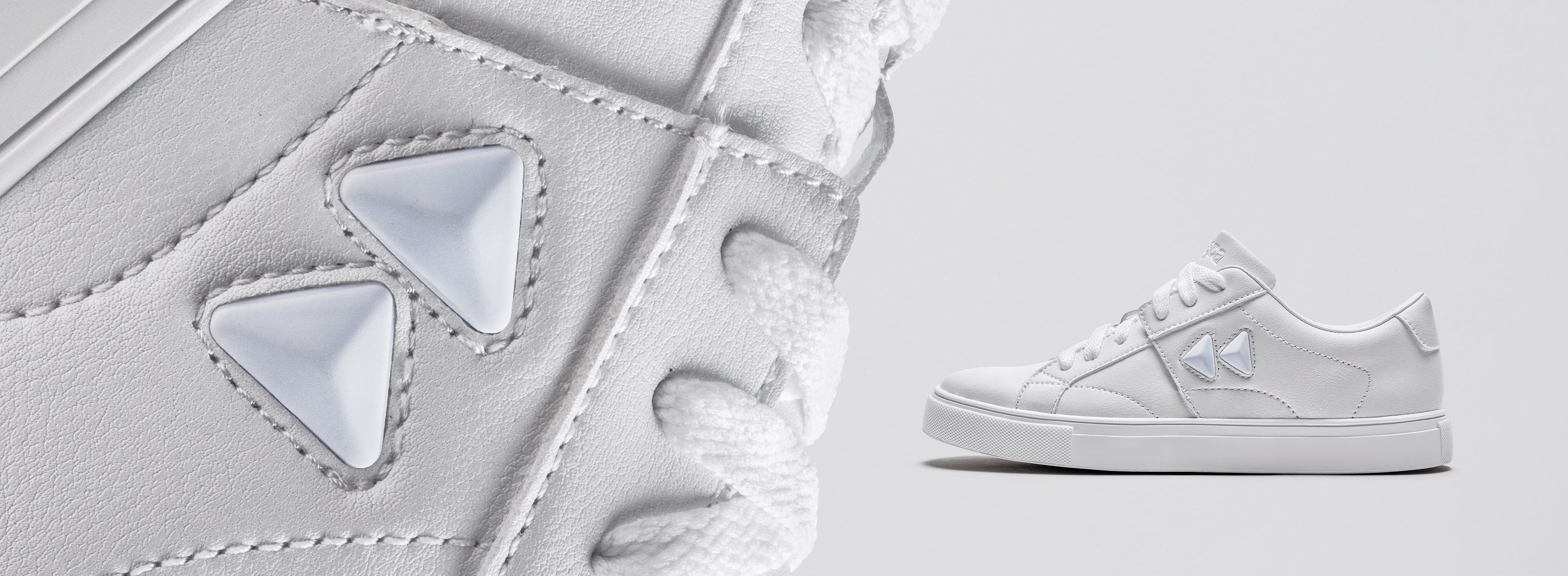 White sneakers with geometric design on a light gray background